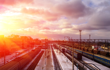 railway station with passenger and freight trains on a background of red sunset. view from above. industrial landscapeのeditorial素材