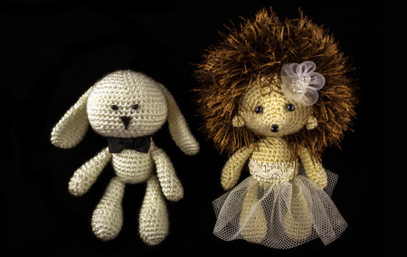 toy braided newlyweds, the bride and groom on a black background. wedding symbols.の写真素材