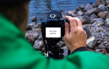 photographer with camera view from the back, a place for a photo of the text.の写真素材