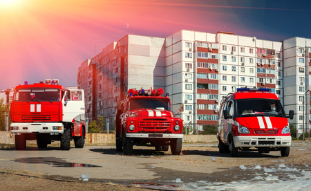 three red fire truck for different purposes at sunset.の写真素材
