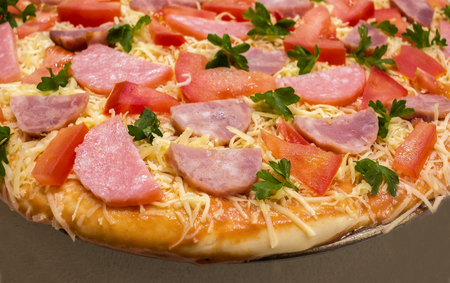 pepperoni raw pizza with  salami, parmesan cheese and tomatoの写真素材