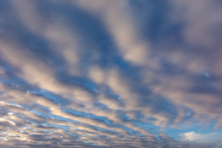 colorful sunset with pocked clouds . Sky background.の写真素材