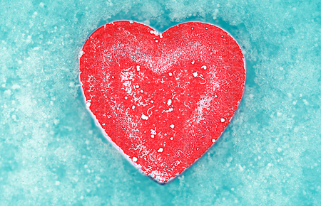 dark heart on a blured of snow. Happy Valentine's day.の写真素材