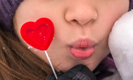 Red heart with a pretty young girl. Happy Valentine's day.の写真素材