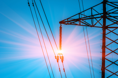  high-voltage  power lines . electricity distribution station at sunset .の写真素材