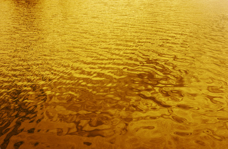 Gold water texture. gold background with waves.の写真素材