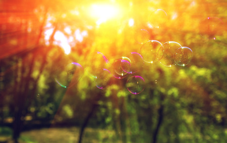 big soap bubbles into the sunset with beautiful bokeh.close-up