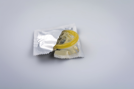 Condom close-up isolated. Contraceptive protection from pregnancy, AIDS.の写真素材