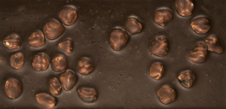 Chocolate background. Milk chocolate with hazelnuts close-up. dark chocolate.の写真素材