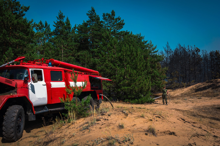 fire truck to put out a forest fire. firefighters to extinguish the fire. wildfireの写真素材
