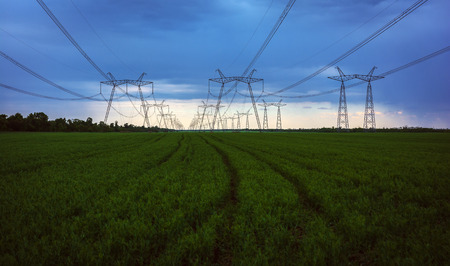 high-voltage power lines at sunset.