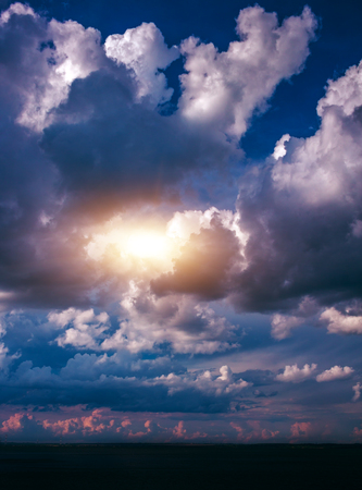 island in the ocean, against a background of beautiful clouds at sunset.の写真素材