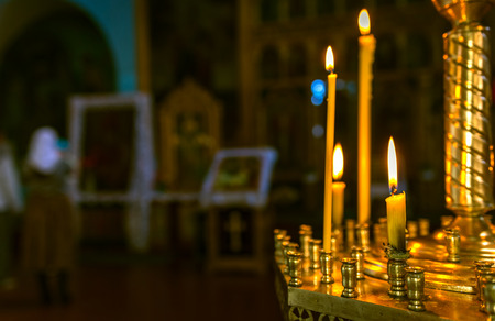 Christening in the church. Catholicism and Orthodoxy, faith. candle on a blurred background.