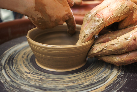 hand maid, molding from clay, making dishes with hands on the machine.の写真素材