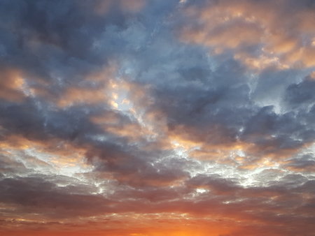 Fiery orange sunset colorful and speckled  clouds. Beautiful sky.