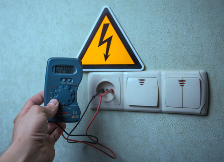 The electrician makes electrical measurements; jumps tension, electrical safety.の写真素材
