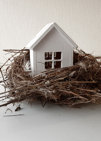 Buying, selling a house, a white house in a nest. house is an investment.の写真素材