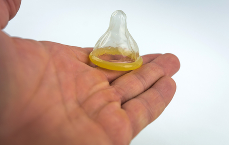 Condom close-up isolated. condom in his hand.の写真素材