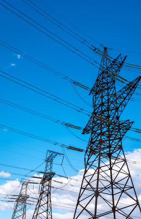 high-voltage  power lines at storm clouds. electricity distribution station. high voltage electric transmission tower.の写真素材