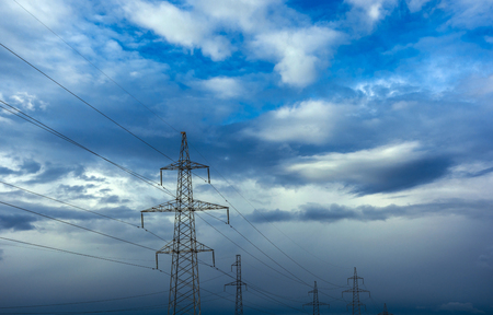 high-voltage  power lines at storm clouds. electricity distribution station. high voltage electric transmission tower.の写真素材