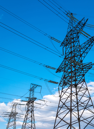 high-voltage  power lines at storm clouds. electricity distribution station. high voltage electric transmission tower.の写真素材