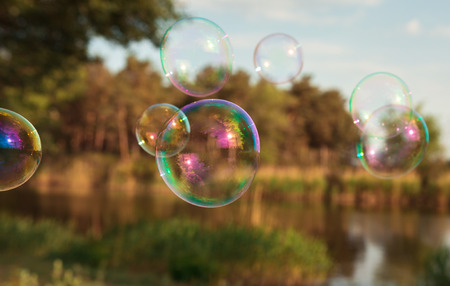 soap bubbles into the sunset with beautiful bokehの写真素材