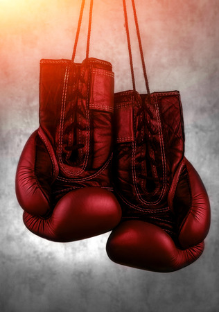 red boxing gloves hanging on the wall, close-up. motivation in sport.の写真素材