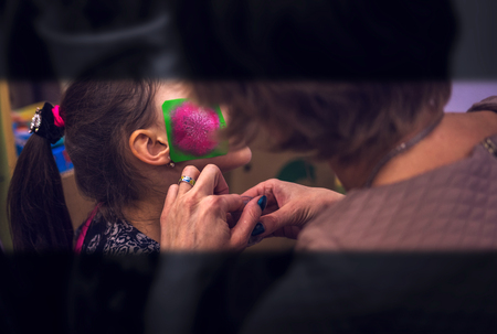 body art patterning on the girl's face. Aqua make-up.の写真素材