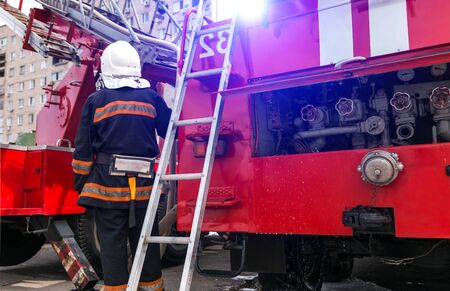 big red fire truck with a ladder close-up.の写真素材