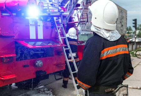 fireman extinguishes the fire with smoke. Firefighting exercises with fire extinguishing.の写真素材