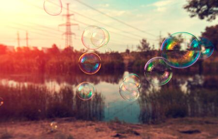 soap bubbles into the sunset with beautiful bokehの写真素材