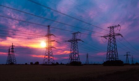 high-voltage  power lines at sunset. electricity distribution station. high voltage electric transmission tower.の写真素材