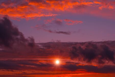 Fiery orange sunset colorful and speckled  clouds. Beautiful sky.