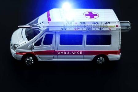  ambulance car with thermometer on blured background. Ambulance auto paramedic emergency. の写真素材