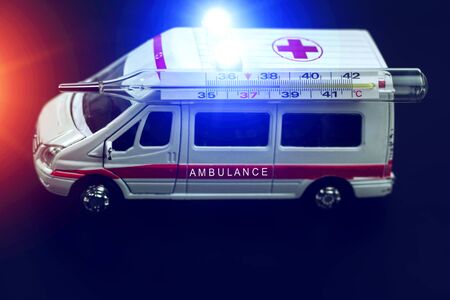  ambulance car with thermometer on blured background. Ambulance auto paramedic emergency. の写真素材