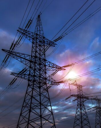  high-voltage  power lines at sunset. electricity distribution station. high voltage electric transmission tower. の写真素材