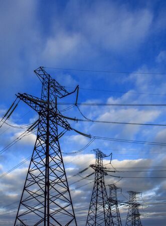 high-voltage  power lines at storm clouds. electricity distribution station. high voltage electric transmission tower.の写真素材