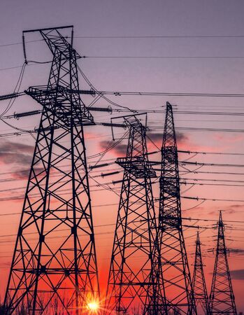  high-voltage  power lines at sunset. electricity distribution station. high voltage electric transmission tower. の写真素材