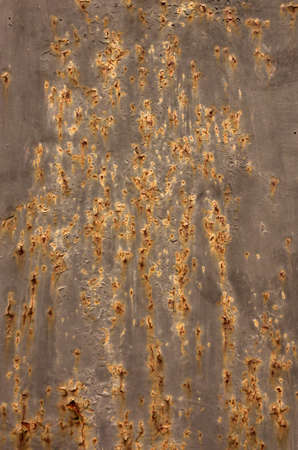 background sheet metal with rust and holesの写真素材
