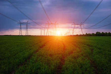 high-voltage power lines at sunset. electricity distribution station. high voltage electric transmission tower.の写真素材