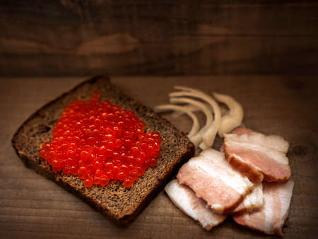 red salmon caviar on a slice of breadの写真素材