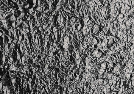 Crumpled paper background vignette. texture of crumpled bronze paper.