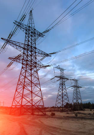 high-voltage power lines at sunset. electricity distribution station. high voltage electric transmission tower.の写真素材
