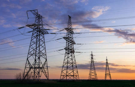 high-voltage power lines at sunset. electricity distribution station. high voltage electric transmission tower.の写真素材