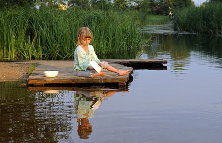 little girl on the river washes upの写真素材