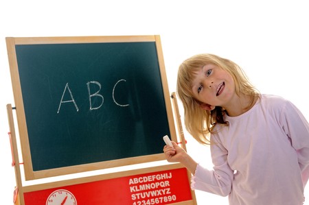 little girl in front of board with ABCの写真素材