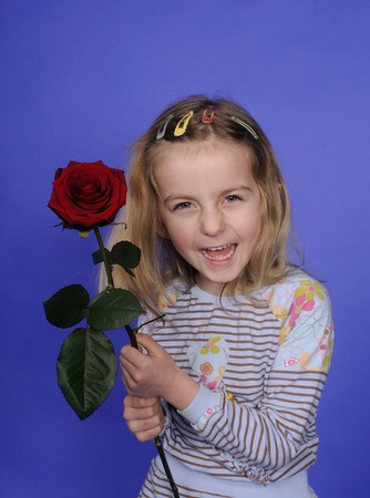 little girl with red roseの写真素材