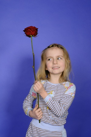 little girl with red roseの写真素材