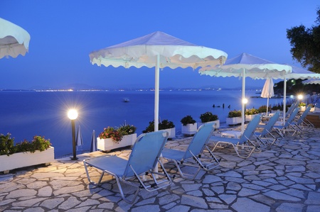 beach umbrellas and sun chairs at swimming poolの写真素材
