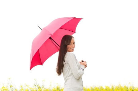  happy young woman with umbrella in canola fieldの写真素材
